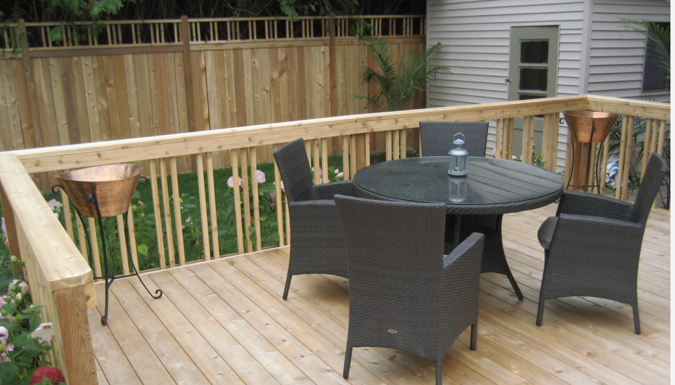 Cedar Deck & Wood Railing installed in Ottawa, Ontario by Fence Masters Ottawa — Cedar deck with a wide-cap wood railing that doubles as a drink ledge