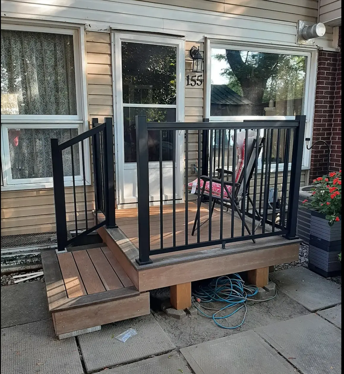 Custom composite front deck with black aluminum railing and accessible gate built by Fence Masters in Ottawa