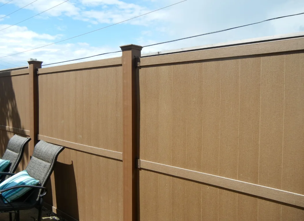 Tan privacy fence with capped posts in an Ottawa backyard.