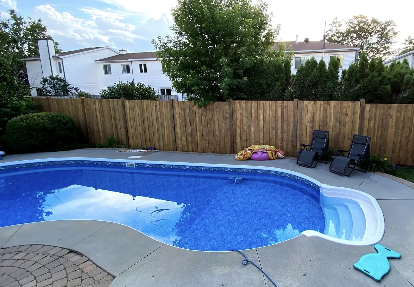 Cedar privacy fence enclosing an inground pool and patio in an Ottawa backyard