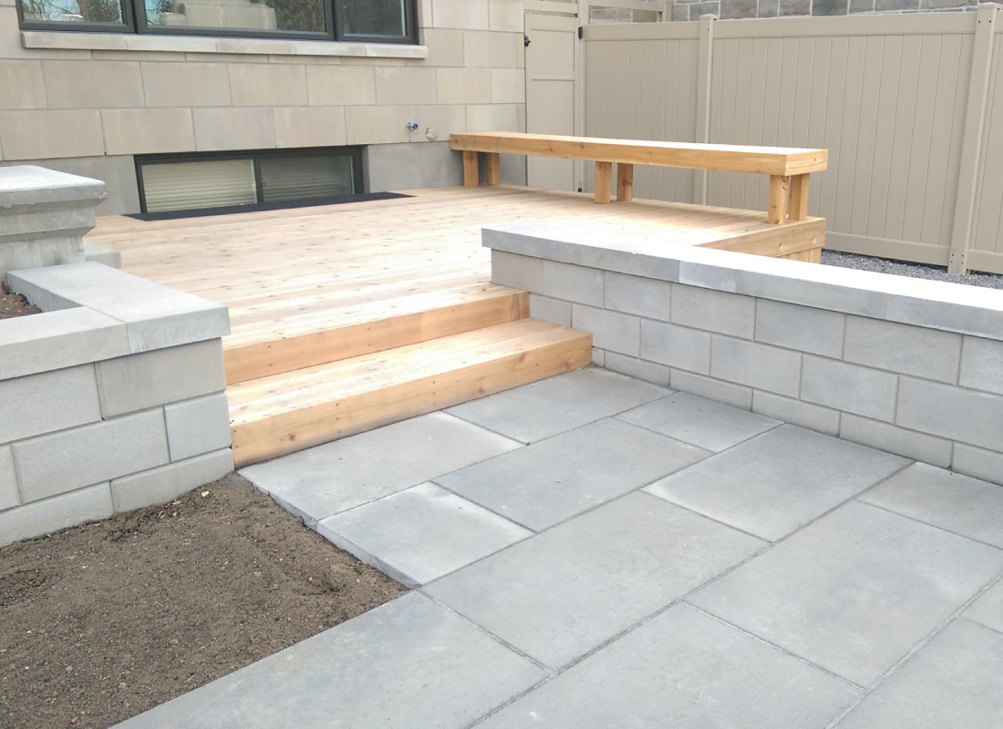 Deck & Landscape Integration installed in Orleans, Ontario by Fence Masters Ottawa — Deck framed into surrounding hardscape and planting for a seamless yard