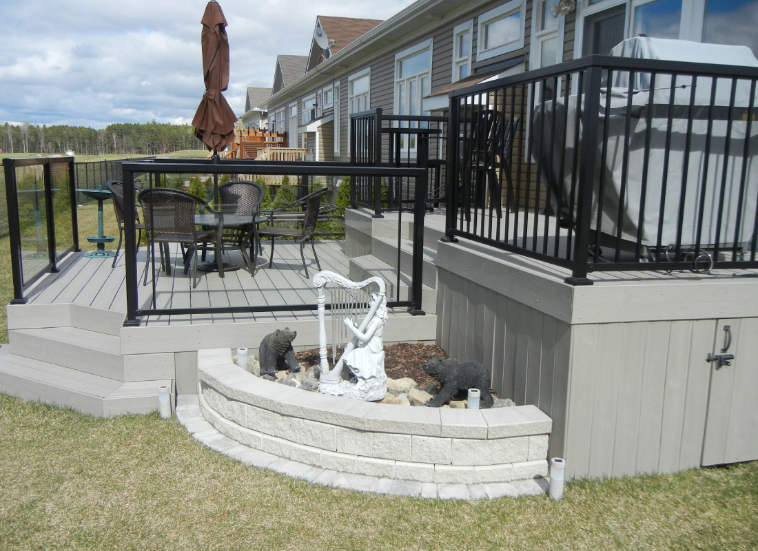 Outdoor Living Deck installed in Manotick, Ontario by Fence Masters Ottawa — Deck and patio transition designed around a full outdoor living zone