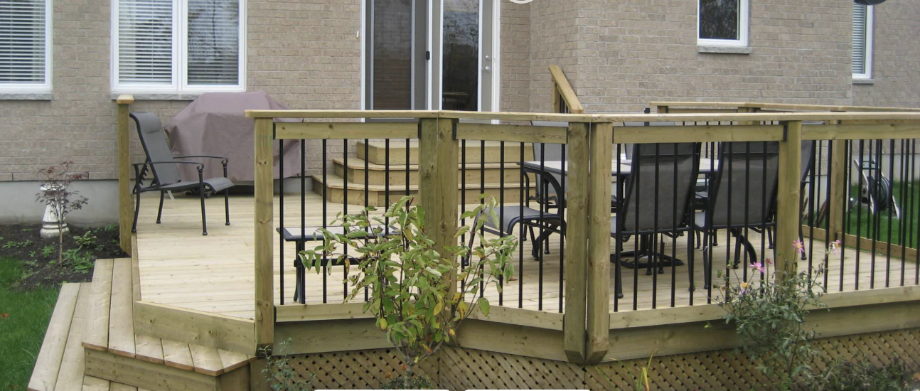 Deck with Aluminum Picket Railing installed in Orleans, Ontario by Fence Masters Ottawa — Wrap-around deck with black aluminum pickets, wood caps and lattice skirting