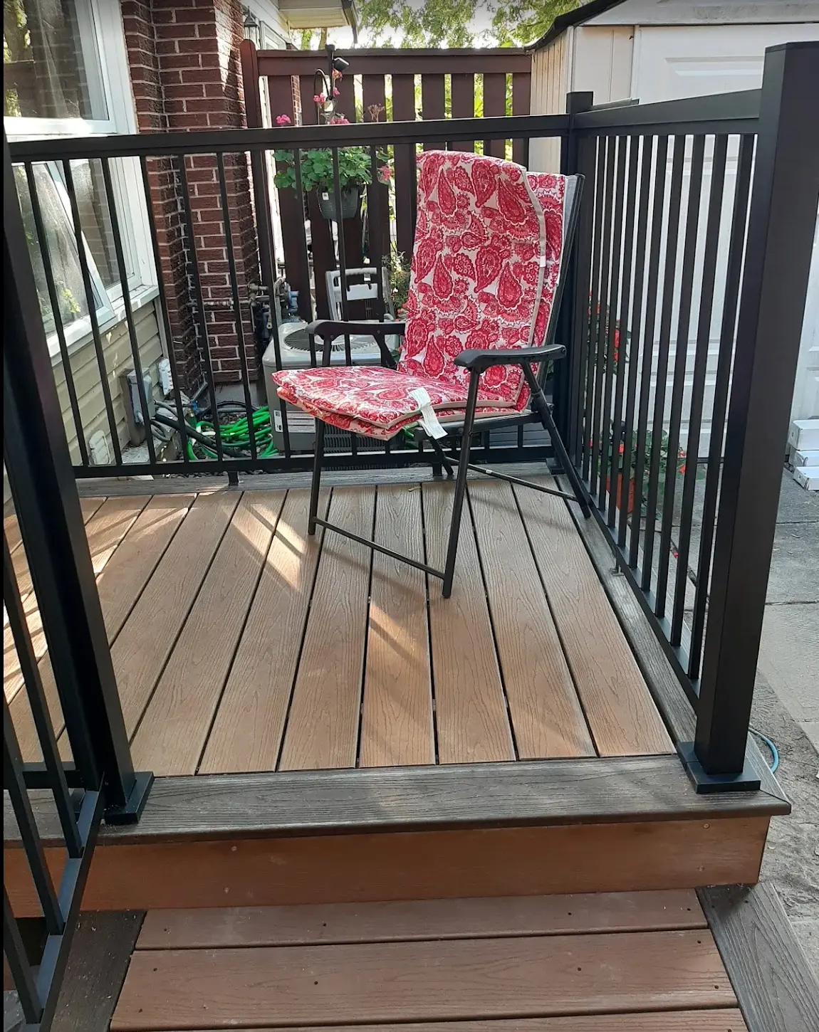 Close view of the composite deck surface and black aluminum railing with wide clearance for mobility