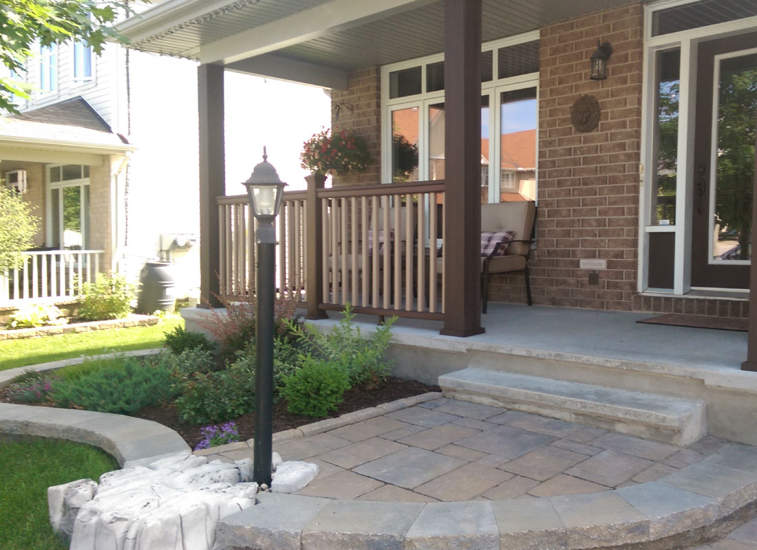 Multi-Level Deck Build installed in Barrhaven, Ontario by Fence Masters Ottawa — Two-tier deck with railing runs stepping down to a landscaped grade