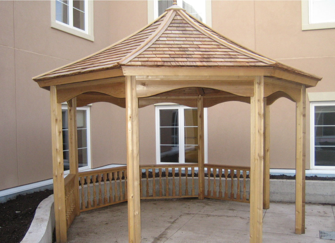 Poolside Pergola installed in Barrhaven, Ontario by Fence Masters Ottawa — Shade structure positioned to shelter a poolside lounge area