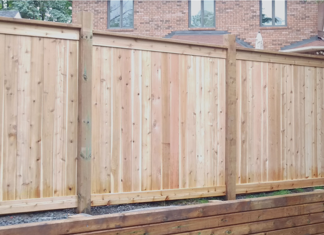 Board-on-Board Cedar Fence installed in Ottawa, Ontario by Fence Masters Ottawa — Full-privacy cedar fence with capped posts and a level top rail