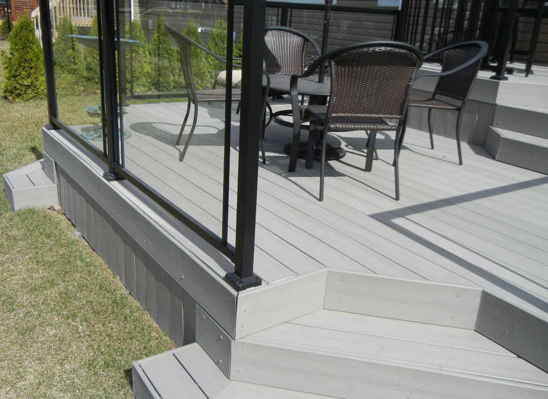 Cedar Backyard Deck installed in Stittsville, Ontario by Fence Masters Ottawa — Cedar deck with wide steps and integrated bench seating for entertaining