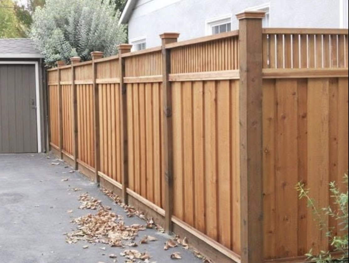 Cedar Fence with Spindle Top installed in Stittsville, Ontario by Fence Masters Ottawa — Board-on-board cedar fence with decorative spindle topper and capped posts